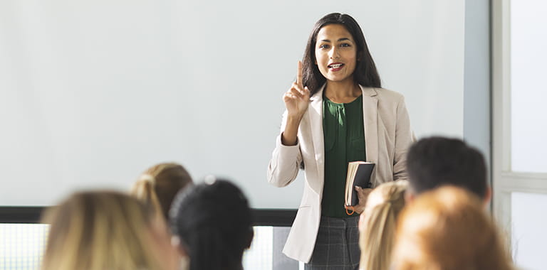 Woman standing and teaching a class