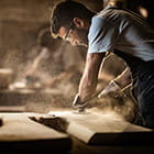 man sanding a piece of wood
